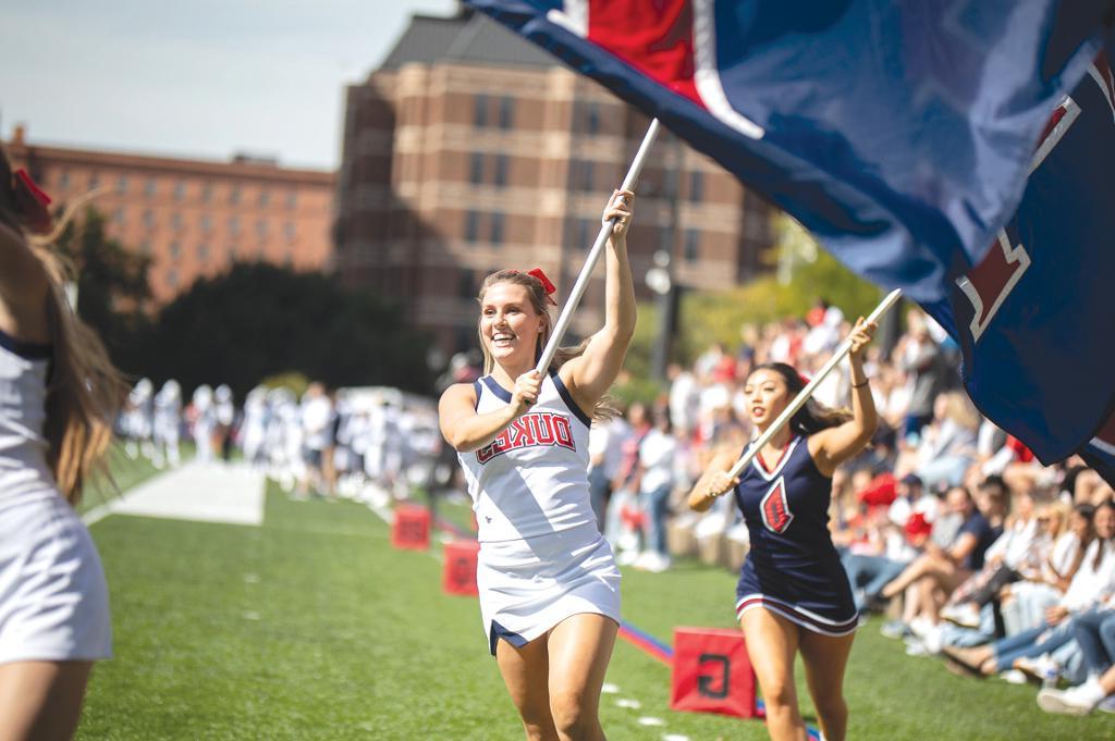 students with Duquesne flags at a sporting event